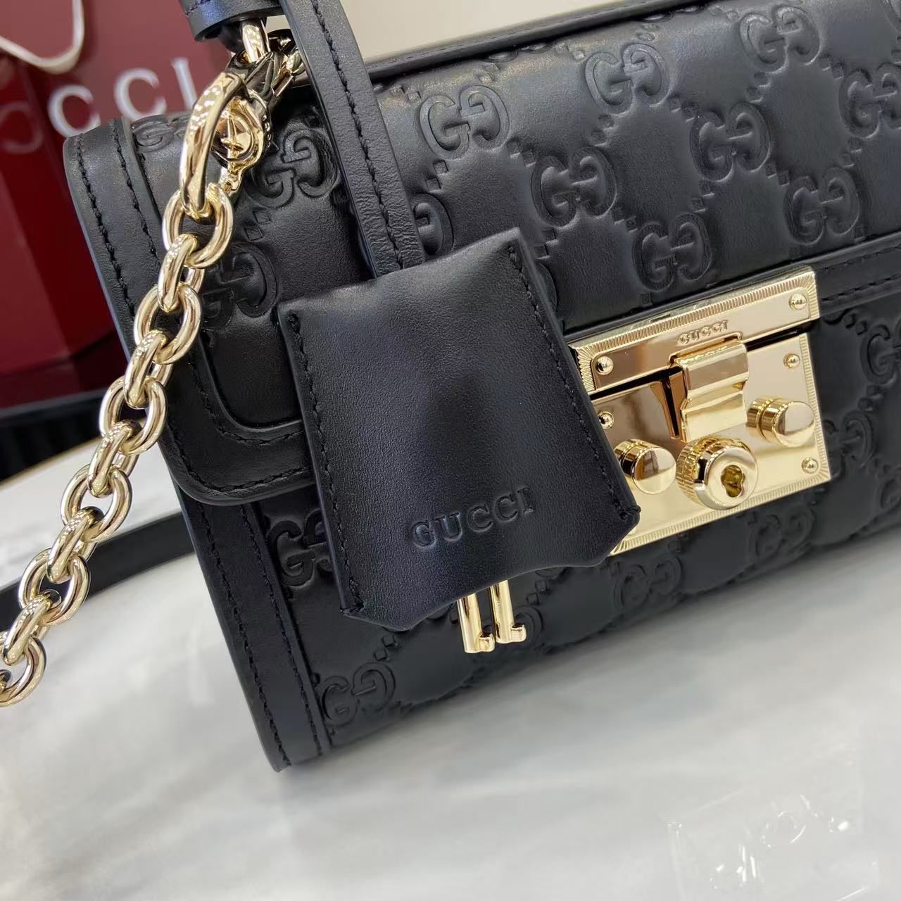 Structured Small Top Handle Bag with Padlock Closure